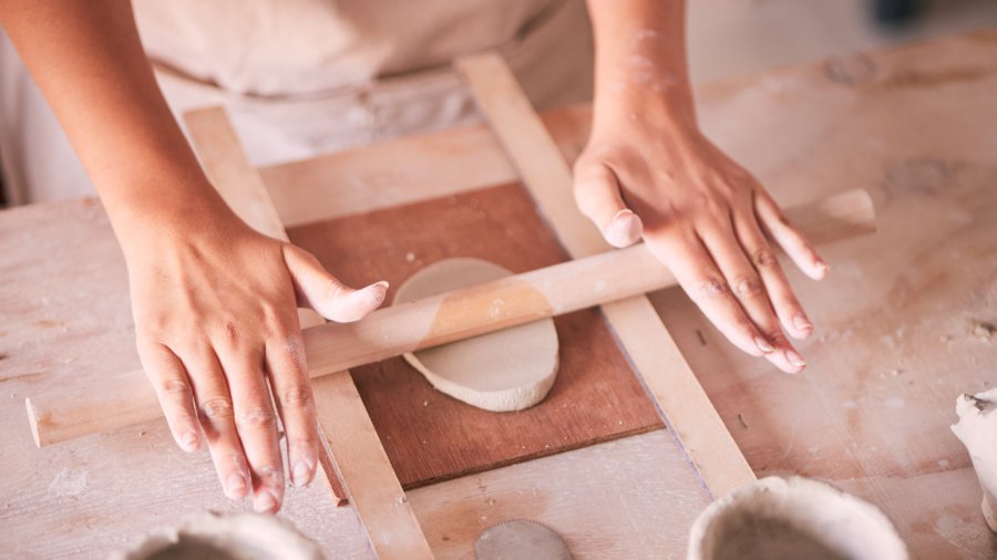 Ceramics, pottery and design with hands of woman in workshop studio for mold, creative and art. Clay, sculpture and manufacturing with girl artisan on table for crafting, handmade and hobby