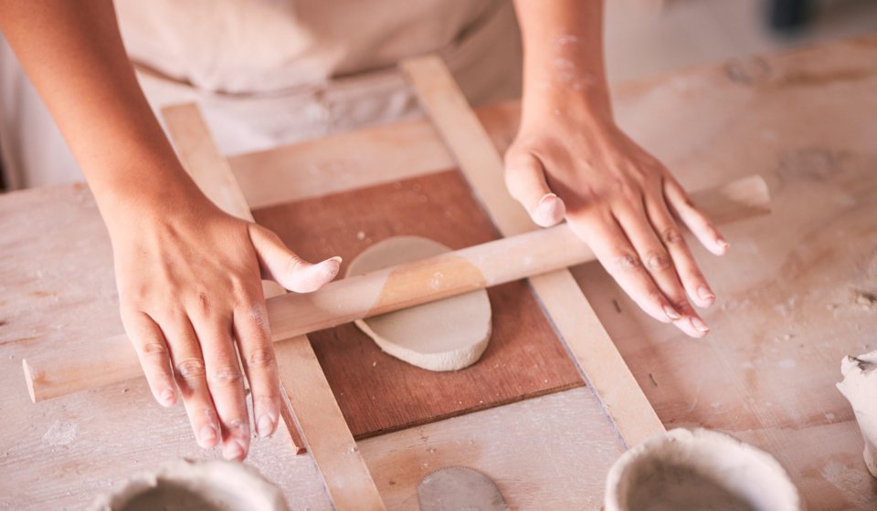 Ceramics, pottery and design with hands of woman in workshop studio for mold, creative and art. Clay, sculpture and manufacturing with girl artisan on table for crafting, handmade and hobby